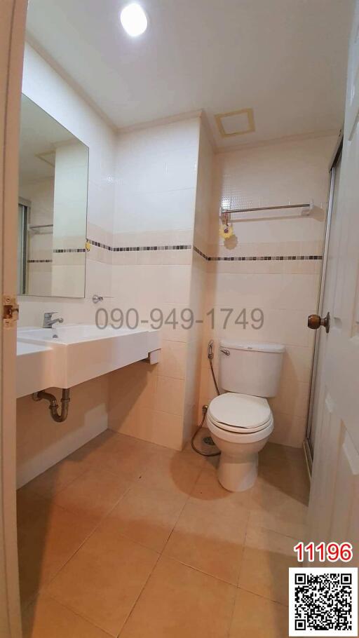 Modern white-themed bathroom with toilet and sink