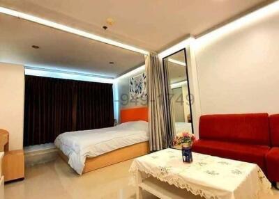 Modern bedroom with bright lighting and comfortable furnishings