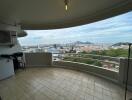 Spacious balcony with city view and outdoor air conditioning unit