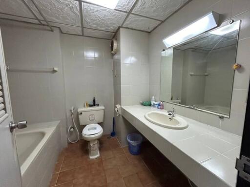 Spacious bathroom with modern fixtures and large mirror