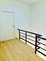 Bright hallway with wooden flooring and white walls