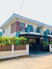 Exterior view of a modern two-story house with balcony