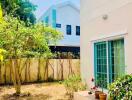 Bright outdoor space with a garden adjacent to a residential building