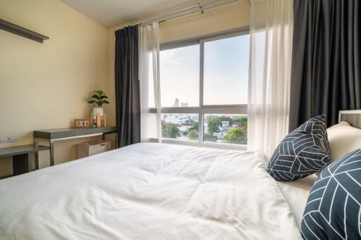 Cozy modern bedroom with natural light and city view