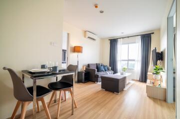 Cozy and well-lit living room with dining area and comfortable seating