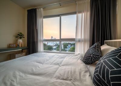 Cozy bedroom with a view at sunset