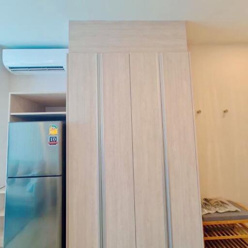 Modern kitchen with tall cabinet and refrigerator