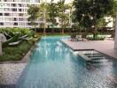 Tranquil residential pool with surrounding greenery and lounge area