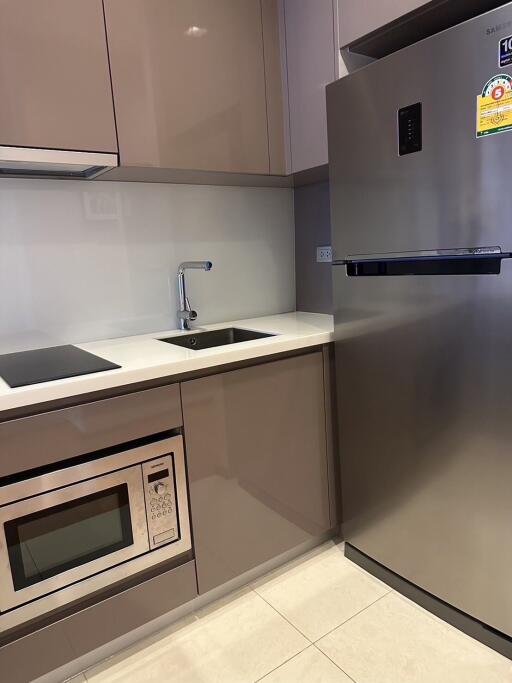 Modern kitchen with stainless steel appliances and built-in oven