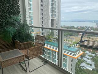 Modern balcony with a view of the cityscape and rattan furniture