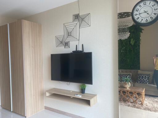 Modern living room interior with mounted television and decorative shelving