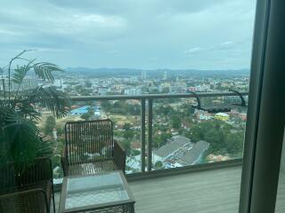 Spacious balcony with a city view and outdoor furniture