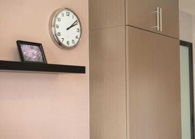 Modern interior with wall clock and wooden cabinet