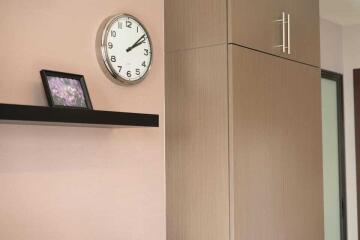 Modern interior with wall clock and wooden cabinet