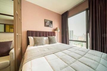 Modern bedroom with large window and city view