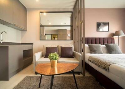 Cozy bedroom with integrated living space including a kitchenette