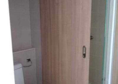 Compact bathroom with wooden cabinet and glass shower door