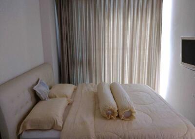 Cozy bedroom with natural light filtering through curtains