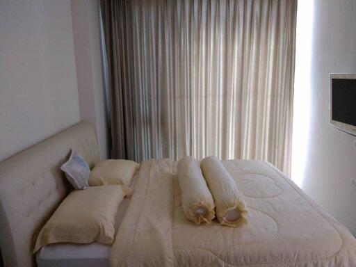 Cozy bedroom with natural light filtering through curtains