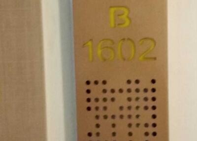 Apartment number B1602 on the door in a residential building