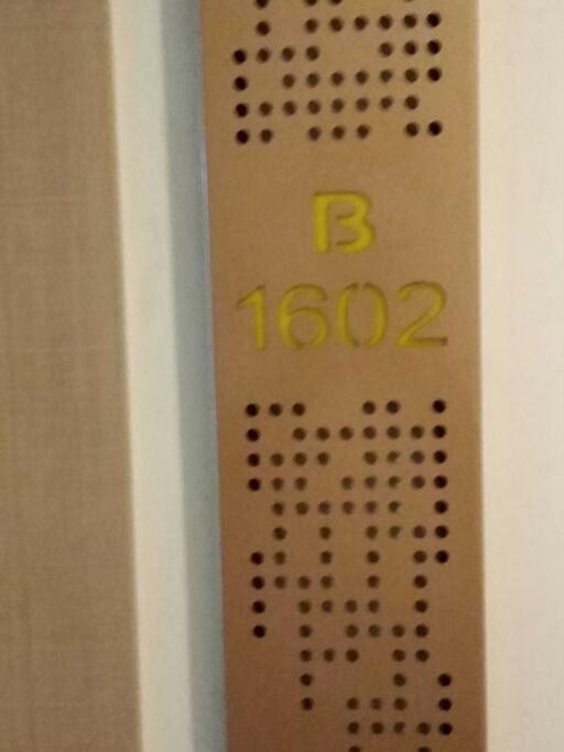 Apartment number B1602 on the door in a residential building