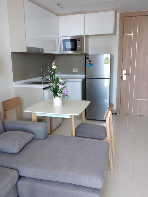 Modern kitchen with stainless steel appliances and dining area