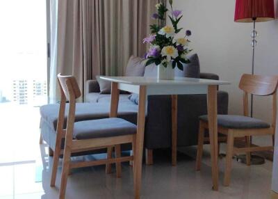 Modern living room with dining area and city view