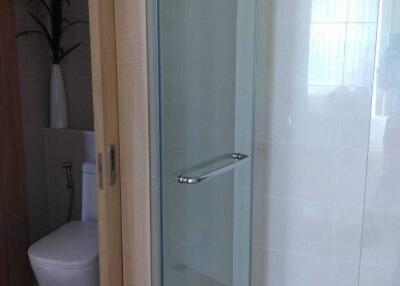 Modern bathroom interior with glass shower and white ceramic fixtures