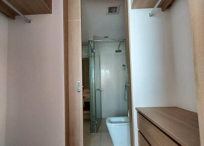 Compact bathroom with modern fixtures and glass shower partition