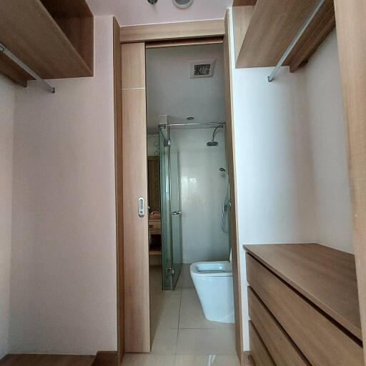 Compact bathroom with modern fixtures and glass shower partition