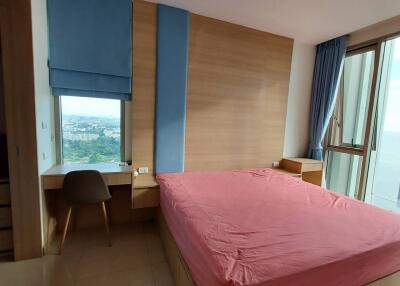 Spacious bedroom with large window and city view