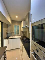 Modern kitchen with stainless steel appliances and white cabinets