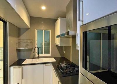 Modern kitchen with stainless steel appliances and white cabinets