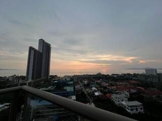 View from the balcony displaying a sunset over the city skyline