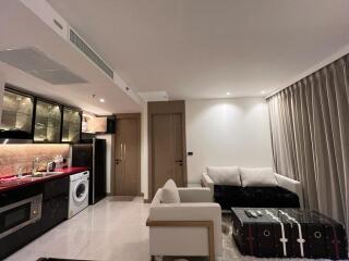Modern studio apartment interior with integrated kitchen, living and sleeping area