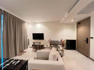 Spacious and modern living room with dining area and entertainment setup