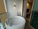 Spacious bathroom with a modern jacuzzi tub and outdoor access