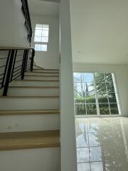 Bright staircase area with large windows and modern design