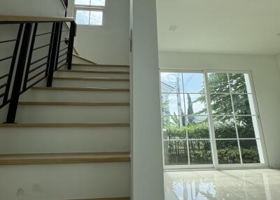 Bright staircase area with large windows and modern design