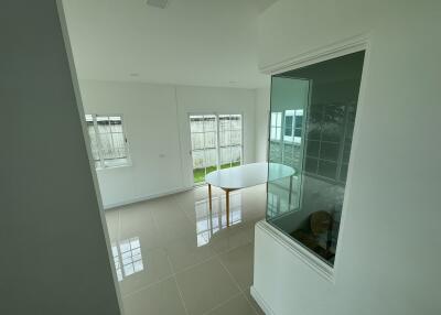 Spacious and bright unfurnished living area with large windows and tiled flooring
