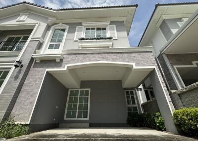 Modern two-story residential home with a spacious carport