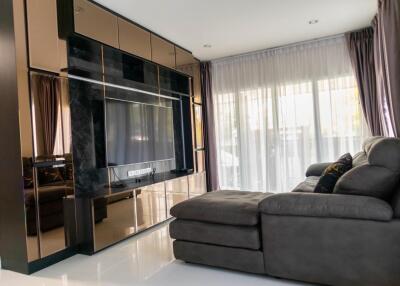 Elegant modern living room with large flat-screen TV and comfortable sofa