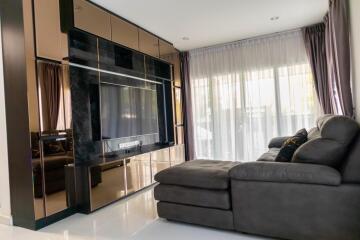 Elegant modern living room with large flat-screen TV and comfortable sofa