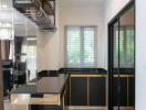 Modern kitchen with black cabinetry, stainless steel appliances, and an open shelving unit