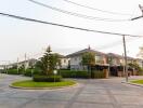 Suburban neighborhood with modern houses and a neatly paved street on a clear day