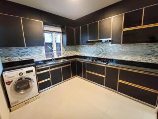 Modern kitchen with black cabinetry and built-in appliances