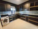 Modern kitchen with black cabinetry and built-in appliances