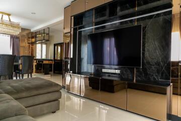 Luxurious and spacious living room with large TV and modern furnishings