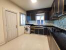 Modern kitchen with stainless steel appliances and mosaic backsplash