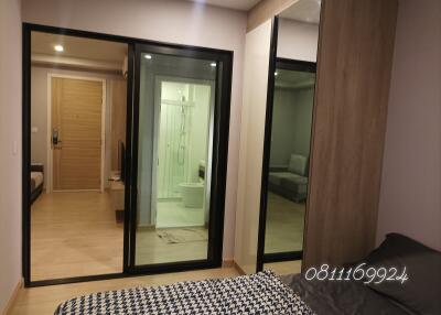 Cozy bedroom with en suite glass door bathroom and additional room access